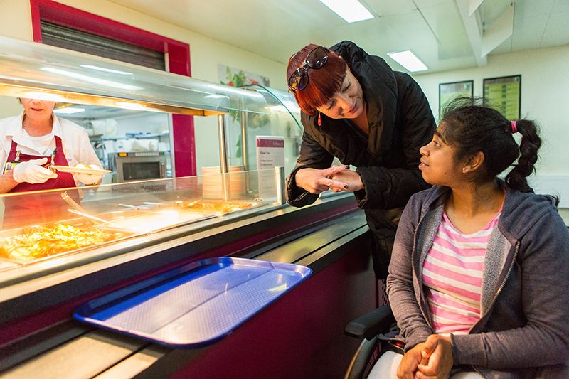 QAC student being served lunch in Dining Room 