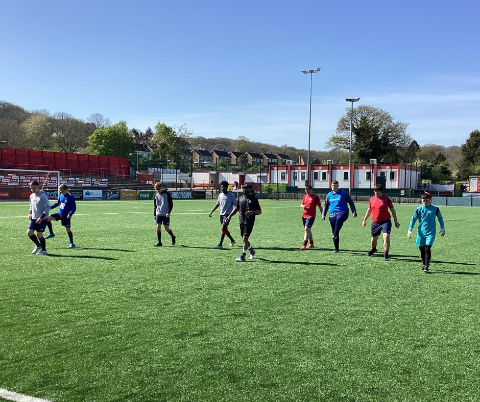 Image of the QAC football players walking down the field