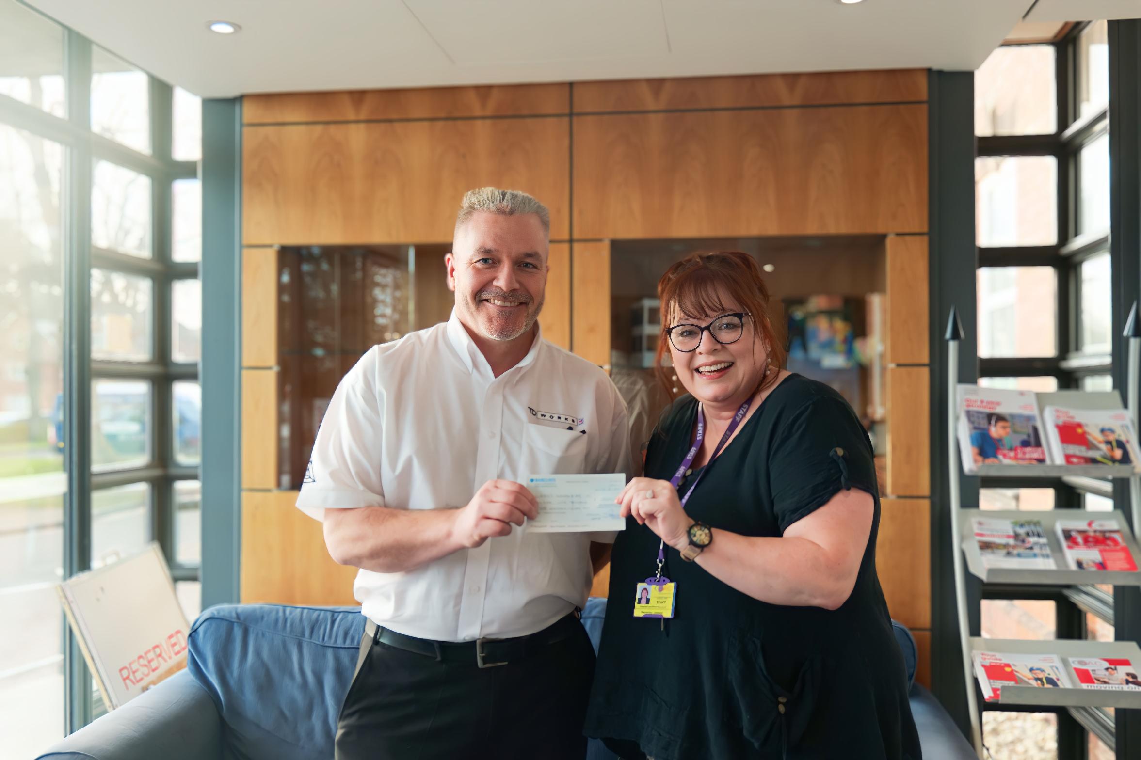 Bev and Barry holding the cheque Bev and Barry holding the cheque