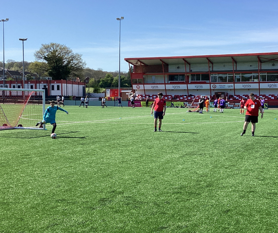 Image of goal keeper kicking the ball back onto the field