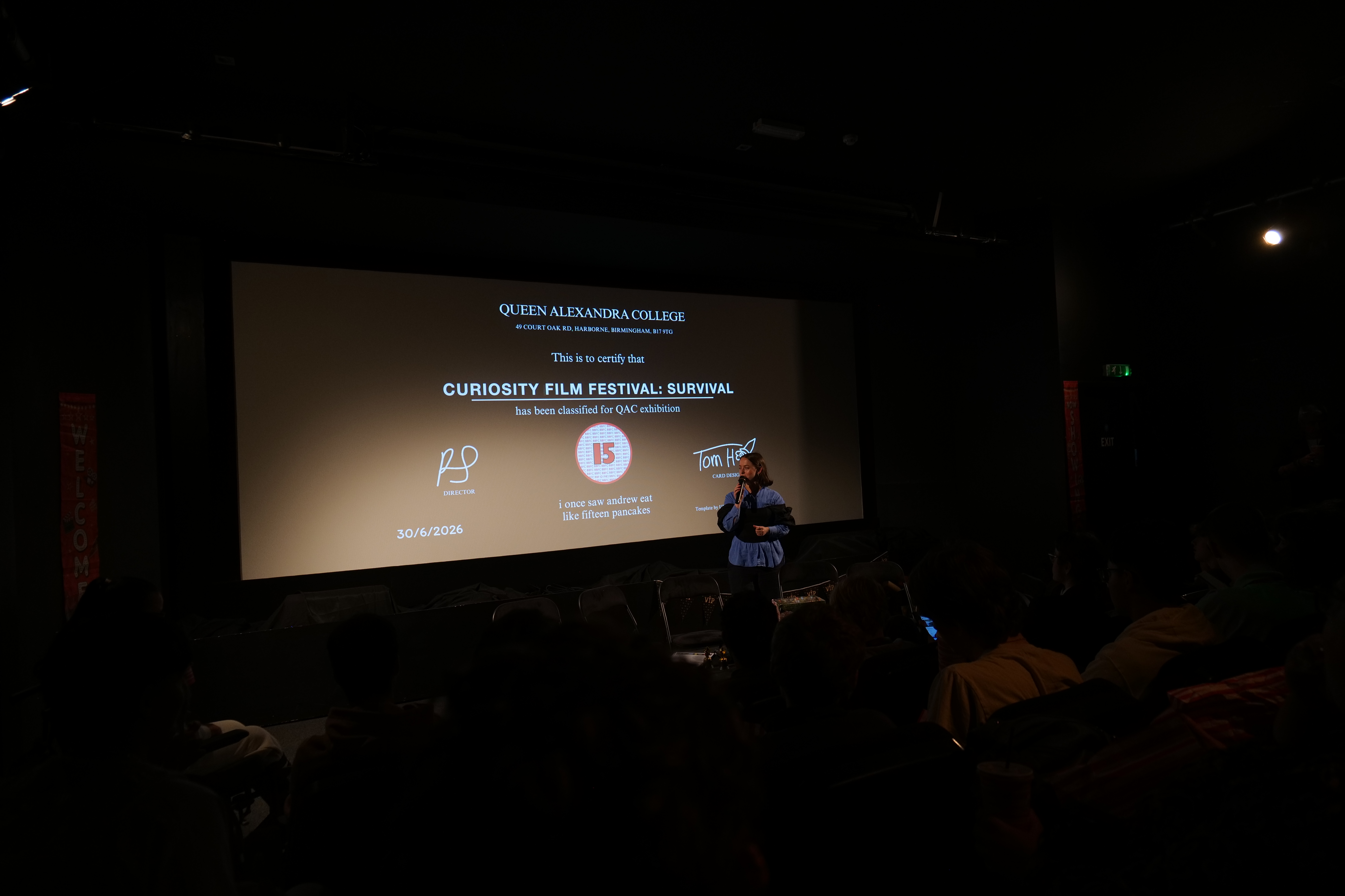 Image of a sign which reads "Mockingbird Cinema, Bar & Café, Curiosity Short Film Festival 2026" Image of Digital Media tutor talking with a microphone in front of a cinema screen