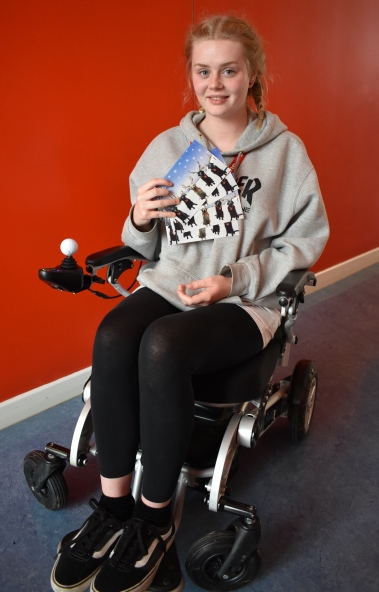 Rebecca holds QAC Christmas cards for 2018 