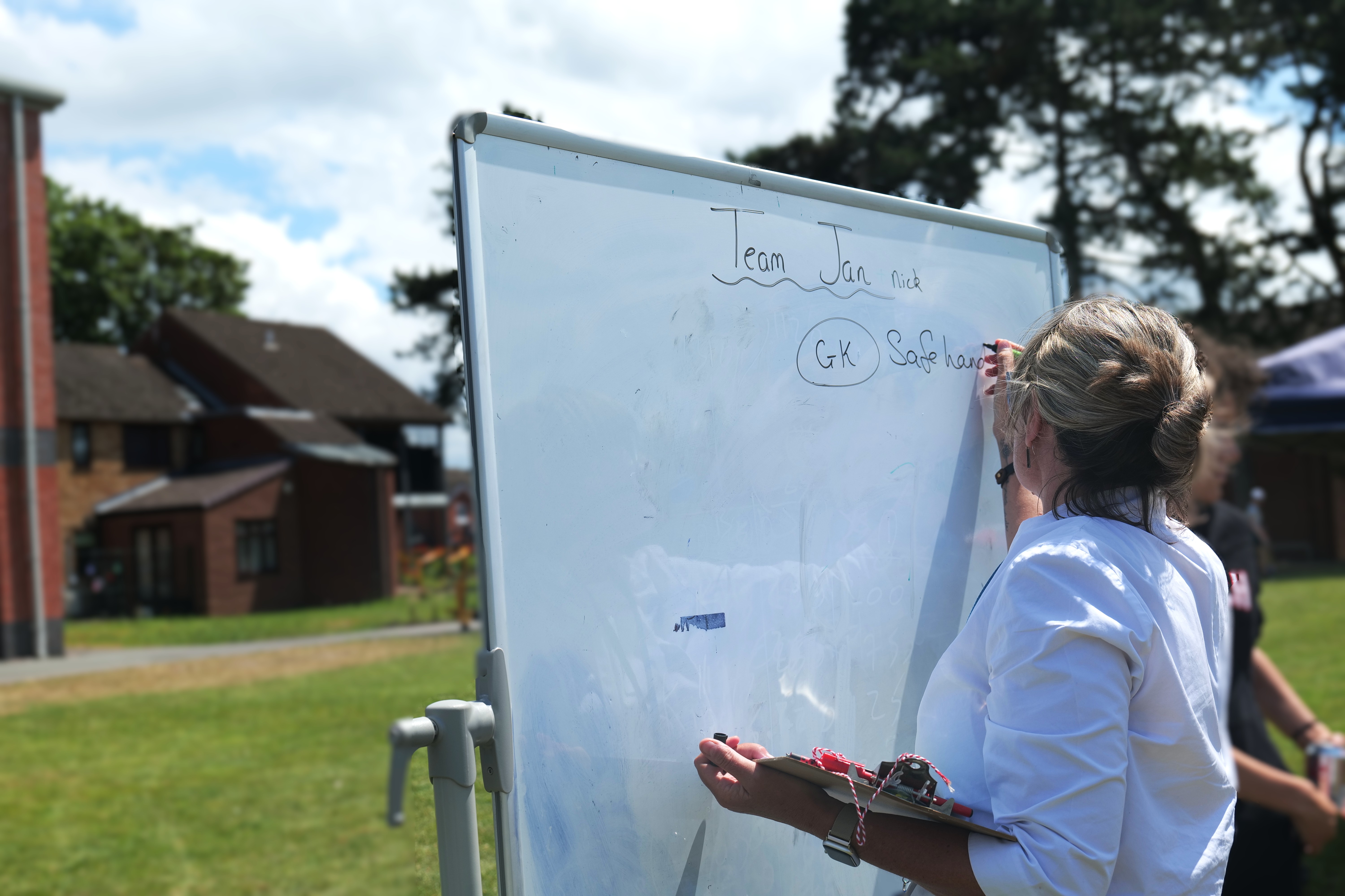 Image of Jan writing on a whiteboard Image of Jan writing on a whiteboard
