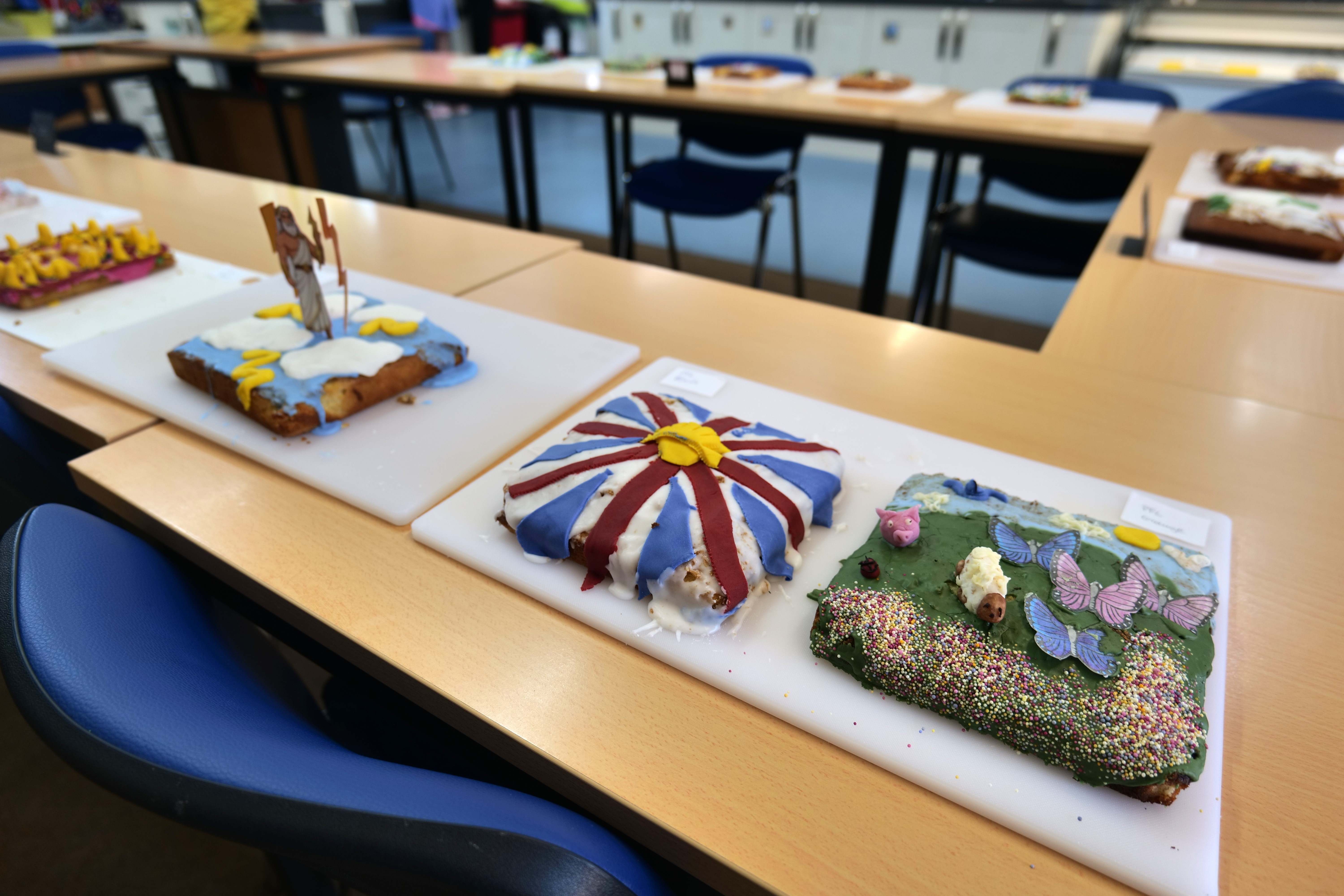Image of a table with 4 decorated cakes Image of a table with 4 decorated cakes