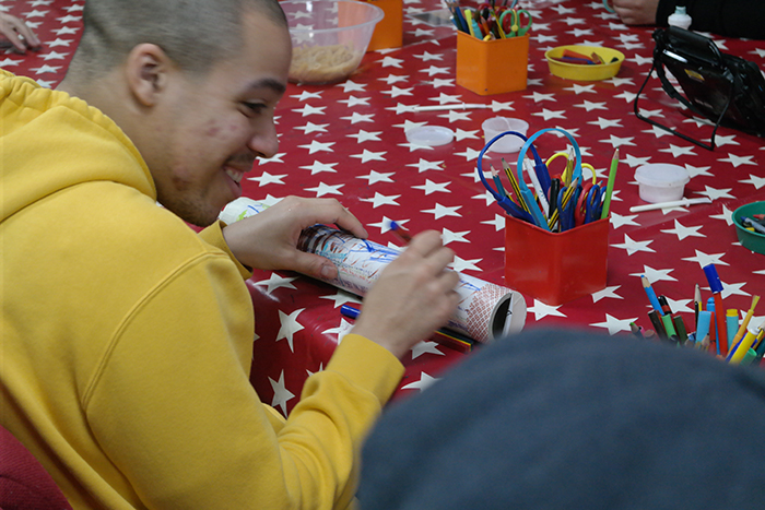 Student using arts & crafts materials to produce art piece