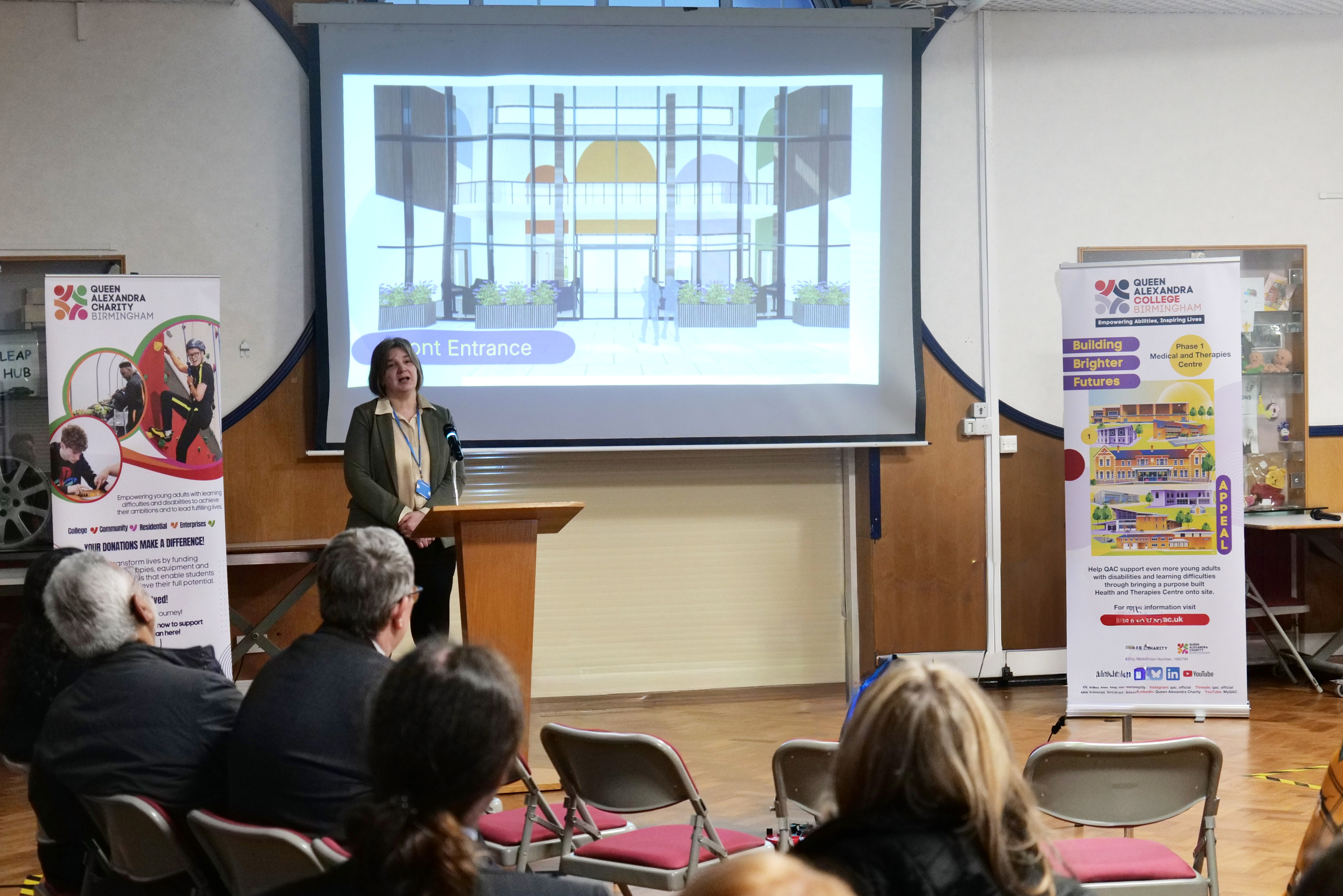 Image of Head of Income Generation, Cathryn, talking to an audience with a presentation in the background