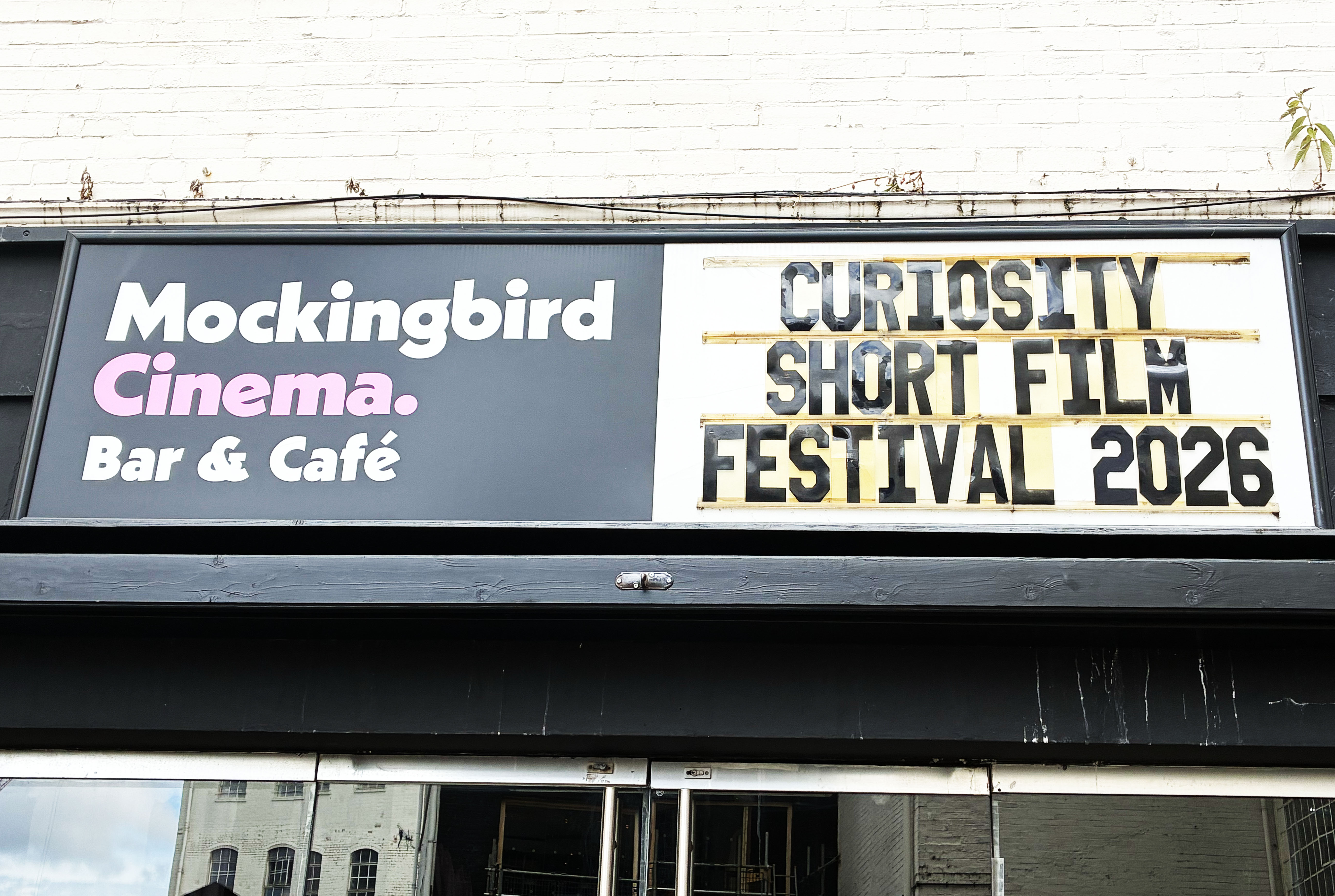 Image of a sign which reads "Mockingbird Cinema, Bar & Café, Curiosity Short Film Festival 2026" Image of a sign which reads "Mockingbird Cinema, Bar & Café, Curiosity Short Film Festival 2026"