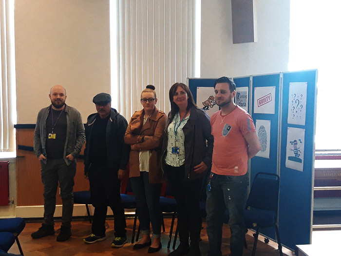 /media/news/library/criminal-web-1.jpg QAC staff "suspects" stood together in the hall
