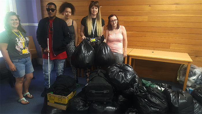 Students and staff pose for a photo with all of the collection bags the students amassed Students and staff pose for a photo with all of the collection bags the students amassed