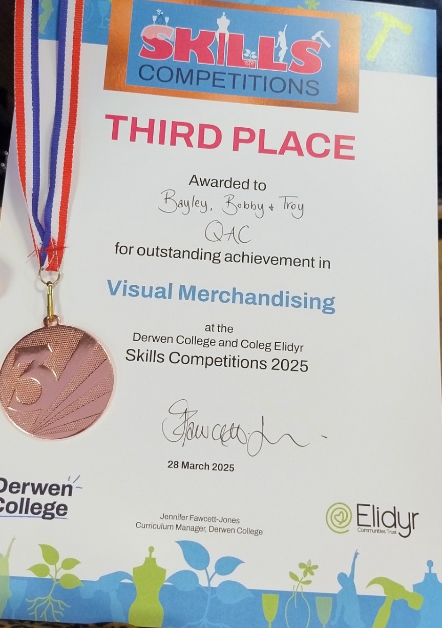 Image of a Certificate and medal with the students names