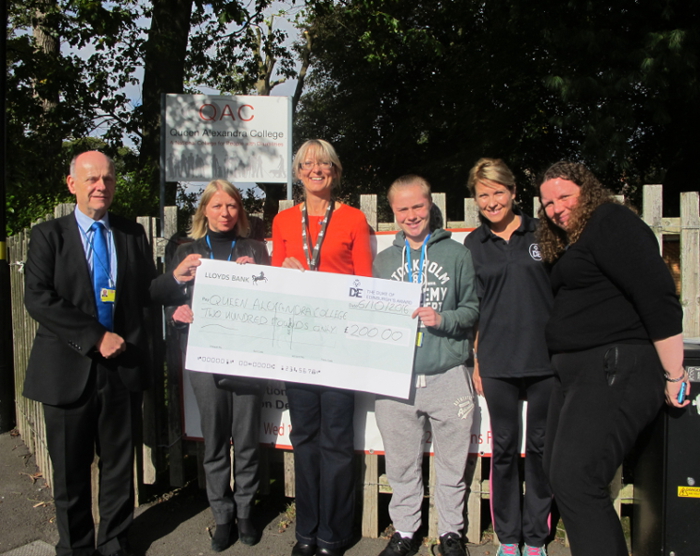 DofE donation cheque being presented to QAC staff