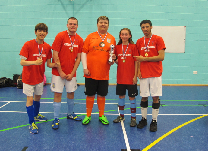 Team QAC with their trophy for winning the Natspec Games Football tournament