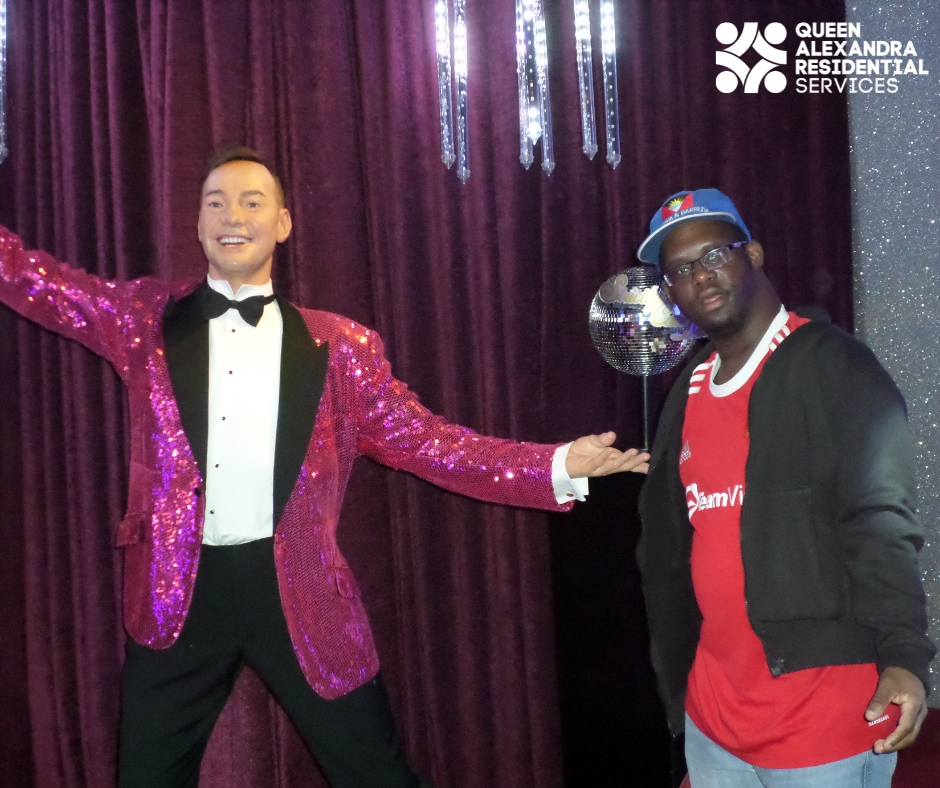 Image depicts, Julio posed beside a wax figure