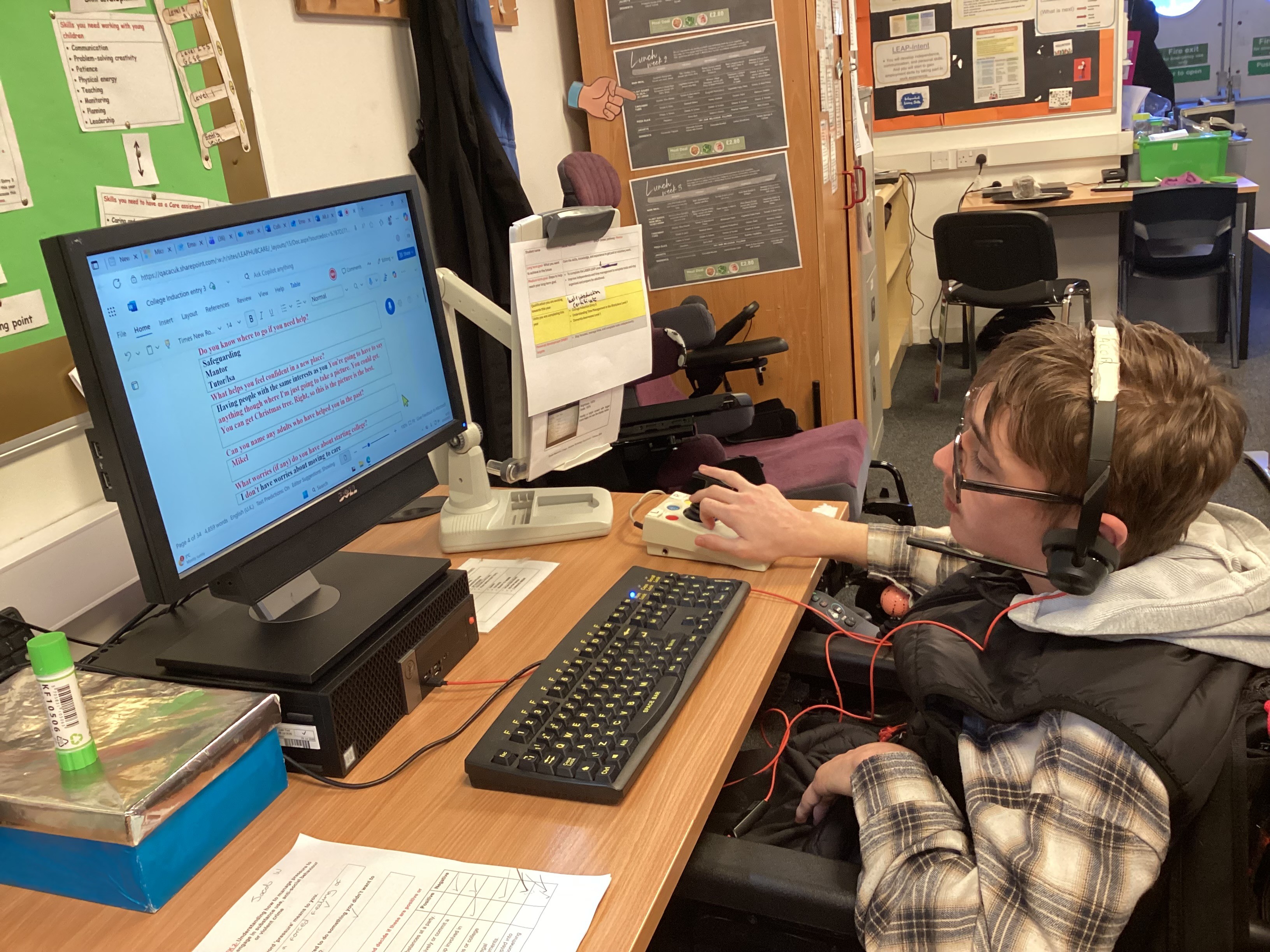Image of Jacob sat at desk looking at a computer screen Image of Jacob sat at desk looking at a computer screen
