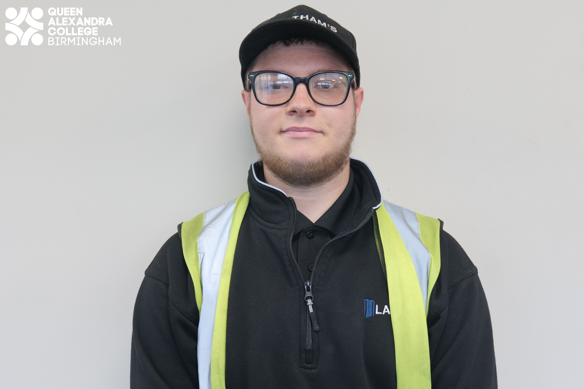 Image of Josh smiling wearing a hi-vis
