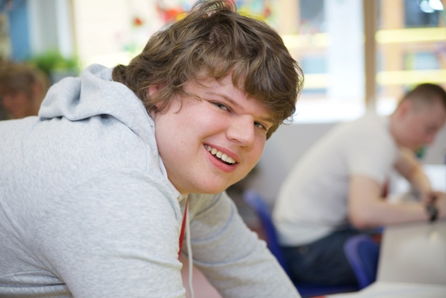 Male student smiles at the camera 
