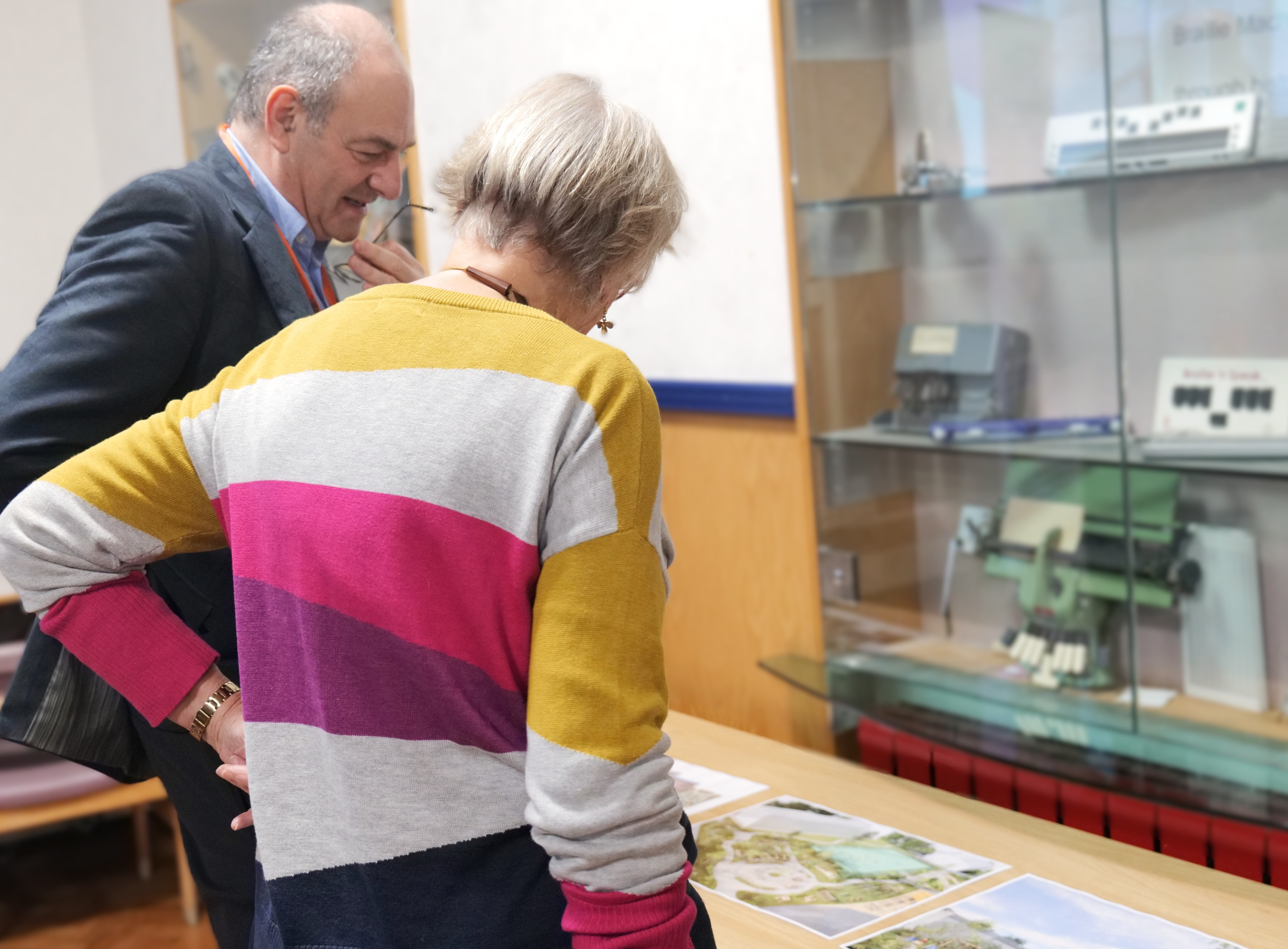 Image of Chair of Governance, Makr talking to a visitor whilst looking a concept photos 