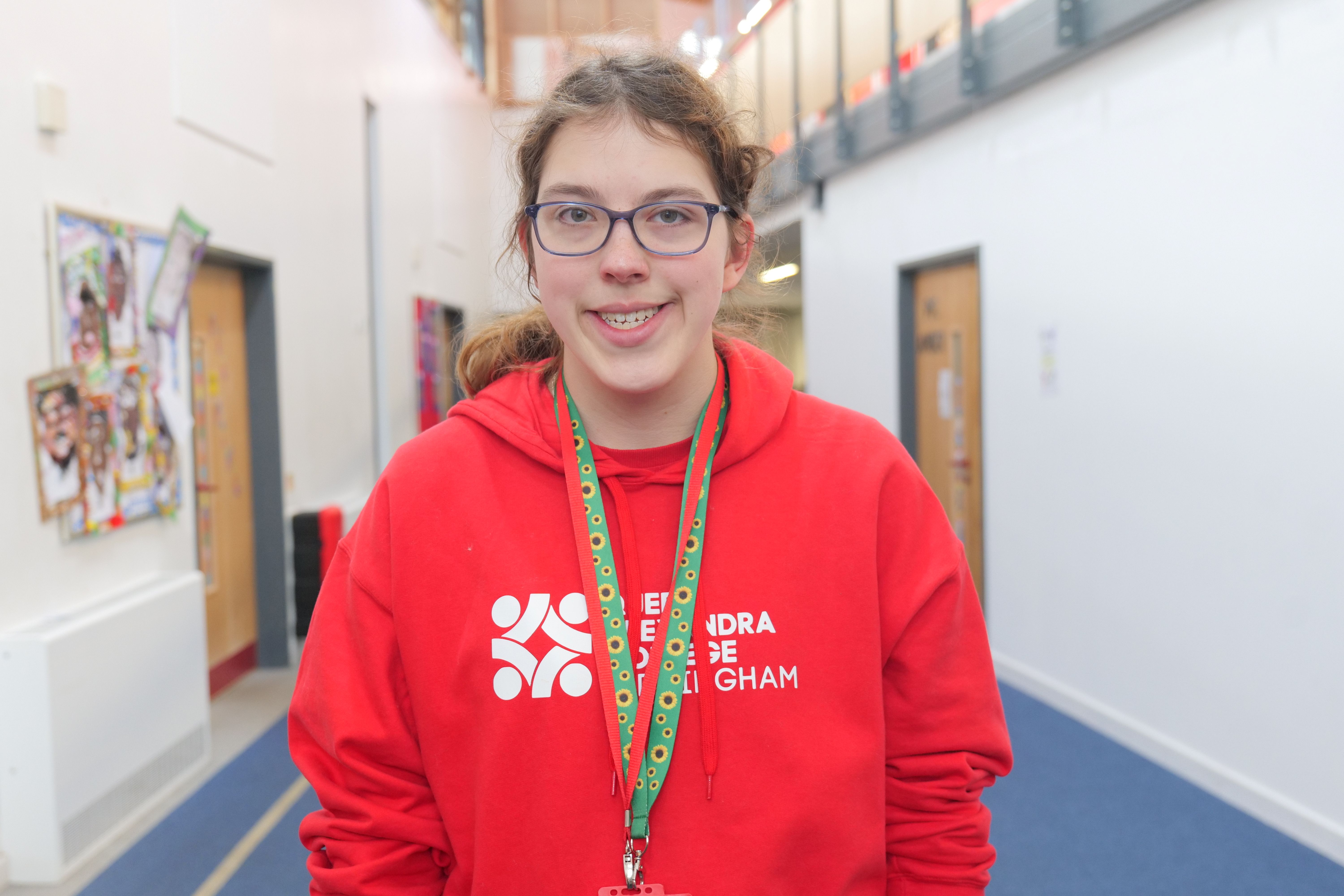 Image of Millie in a red QAC jumper
