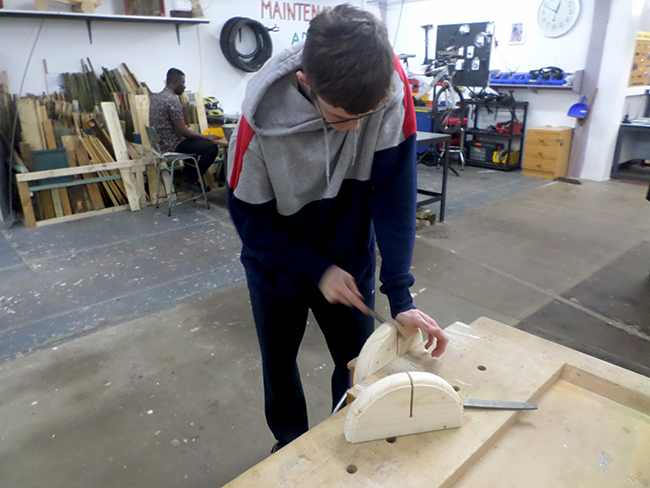 Student works on making the wooden base for the protective screens Student works on making the wooden base for the protective screens