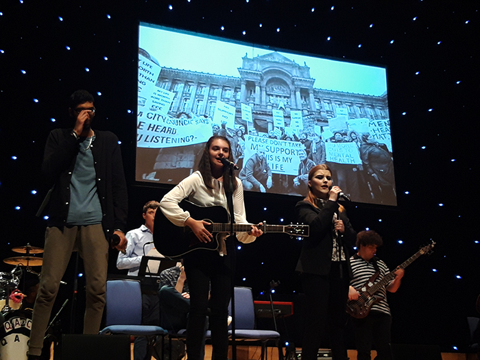 Members of the QAC Collective perform one of their chosen songs on stage at the Birmingham Town Hall Members of the QAC Collective perform one of their chosen songs on stage at the Birmingham Town Hall