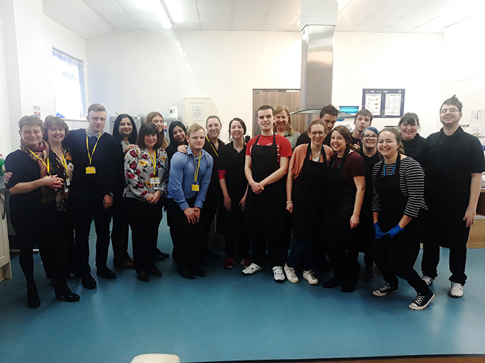 Employees from RBS and Hospitality students have a photo taken together