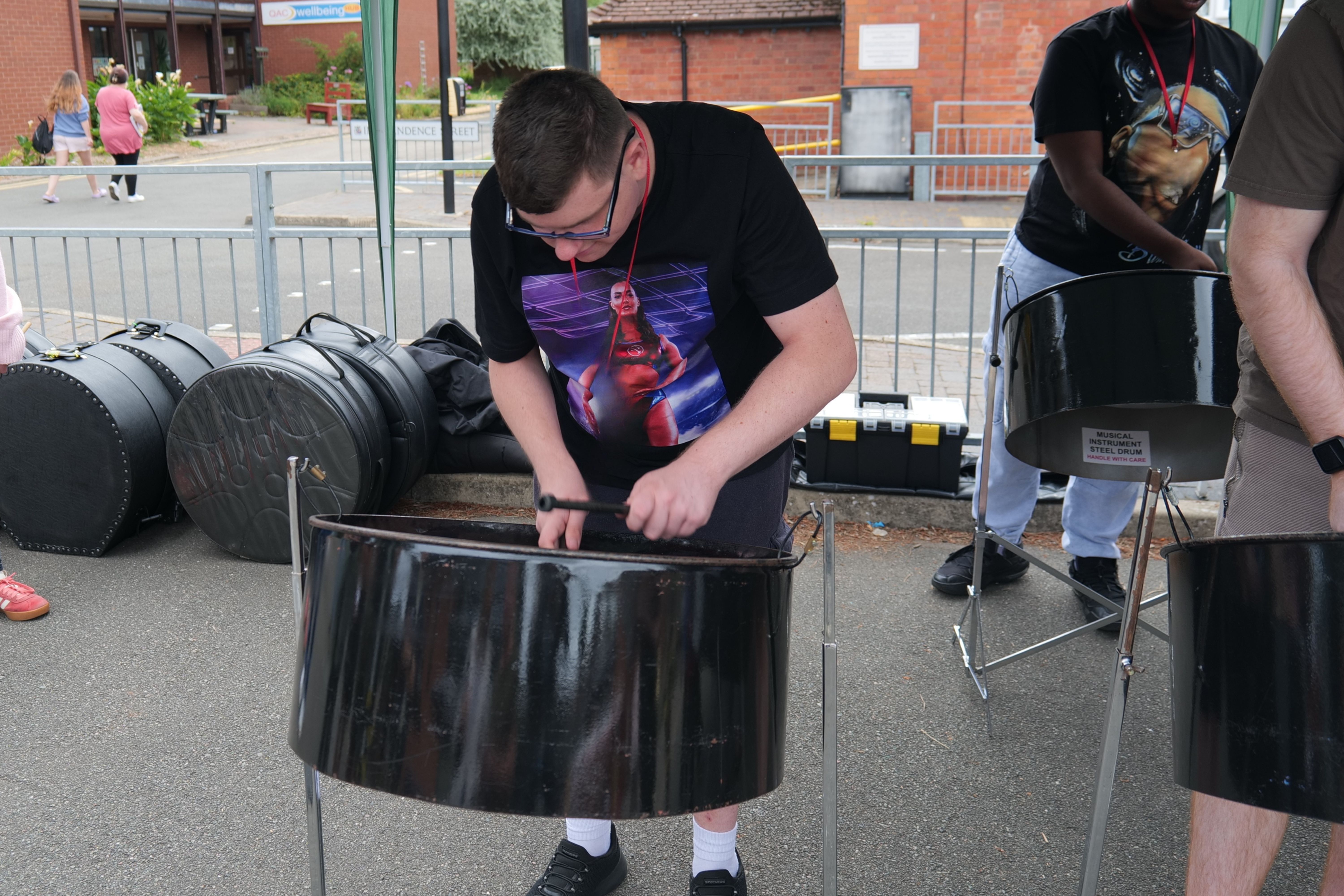 Image of a student playing a steel drum Image of a student playing a steel drum