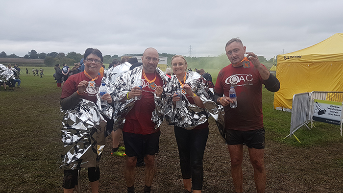 Team QAC Runners after the race posing for photo with their medals