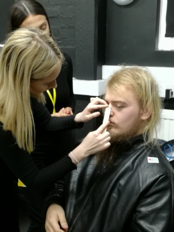 QAC Student getting makeup done by UCB student