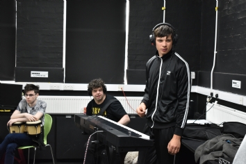 QAC Students preparing to record music instruments
