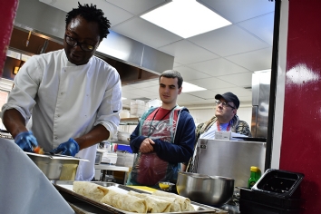 Chef Zeph demonstrates cooking method to students