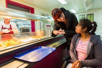 QAC student is served lunch in the dining room