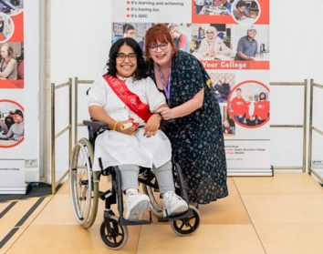 Student and QAC Principal pose for photograph