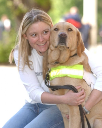 Girl sitting with Guide Dog