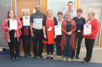 QAC staff with certificates