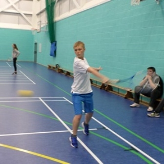 QAC student playing indoor tennis