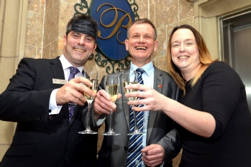 Event organisers hold a glass of Champagne