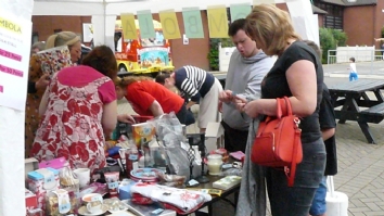 Group of people around a stall at the Summer Fete