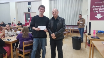 Curry & Quiz winning prize being collected