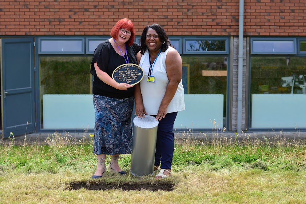 Two members of staff by Time Capsule burial site