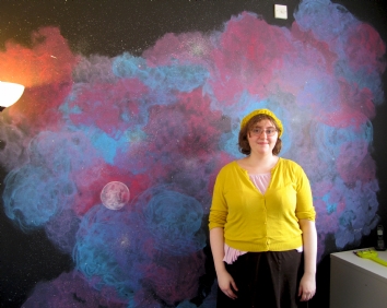Alison next to one of her wall murals