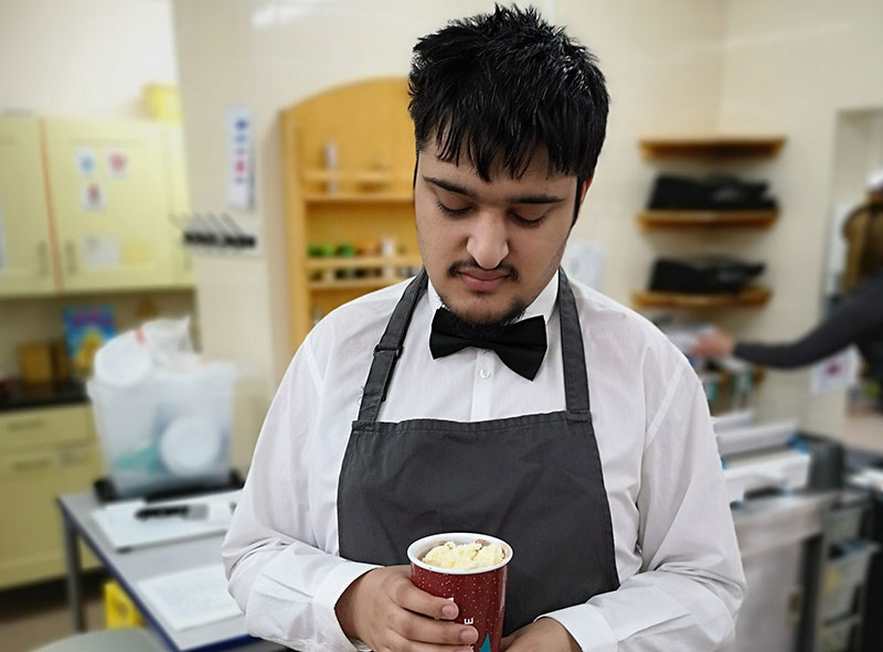 QAC student makes a hot drink in kitchen area