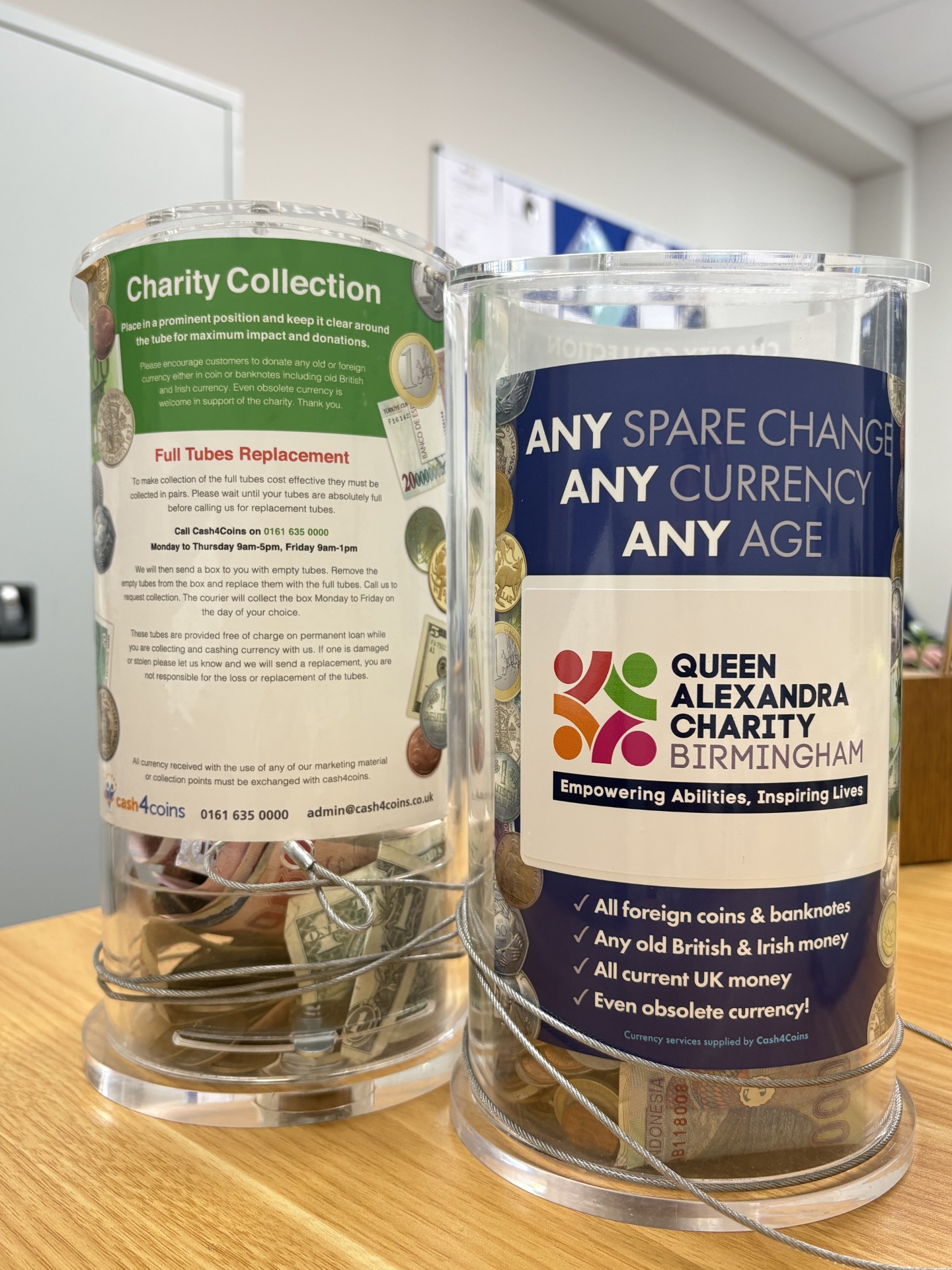 2 charity collection jars used for currency donation